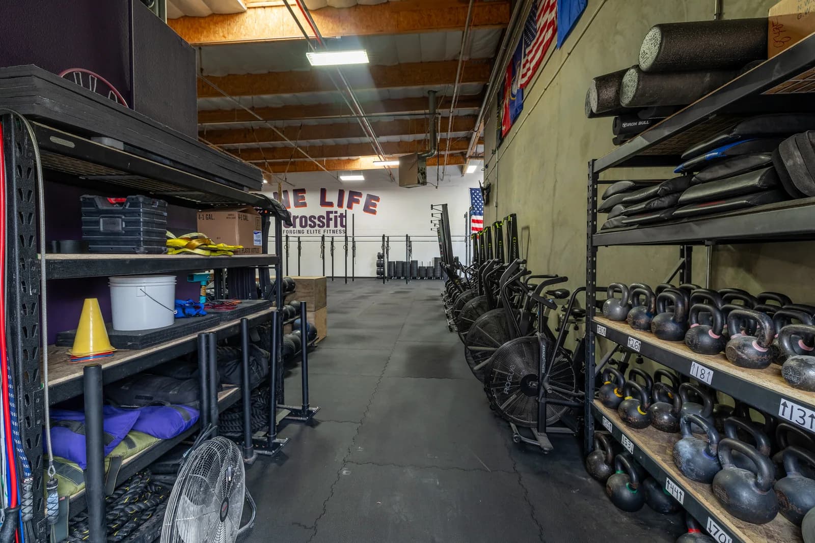 Kettlebells, mats, conditioning equipment, and open training lanes inside One Life CrossFit